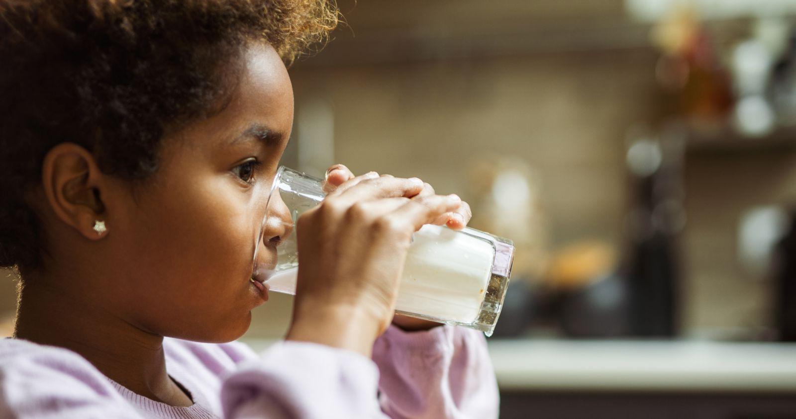 Young Girl Drinking Glass of Milk